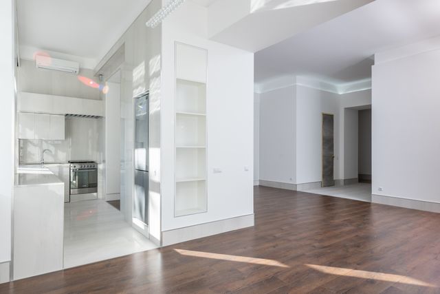 empty modern interior featuring an open kitchen and living area