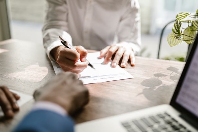 two people at a desk reviewing paperwork